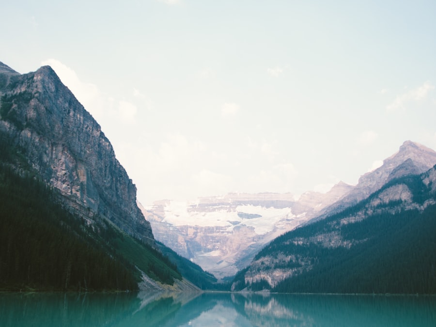 Turquoise alpine lake perfectly mirroring snow-capped mountains